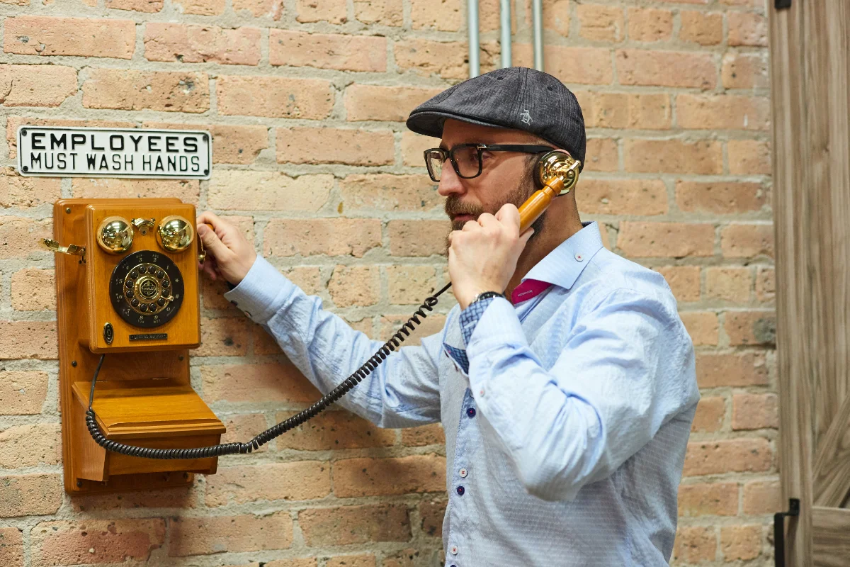 Burak using vintage phone on the wall